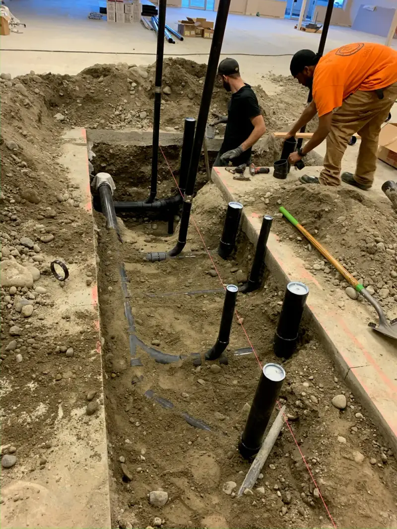 Under-slab ABS drain and waste pipe rough-in at a new construction site